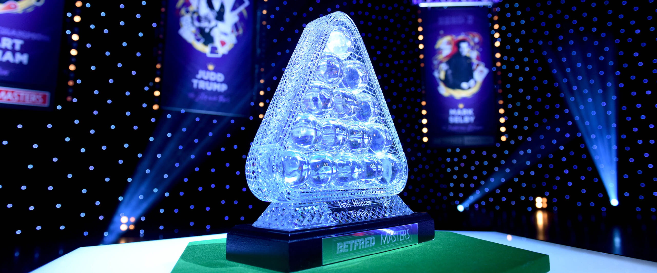 The Cazoo Masters trophy from the side, lit up in blueish lighting