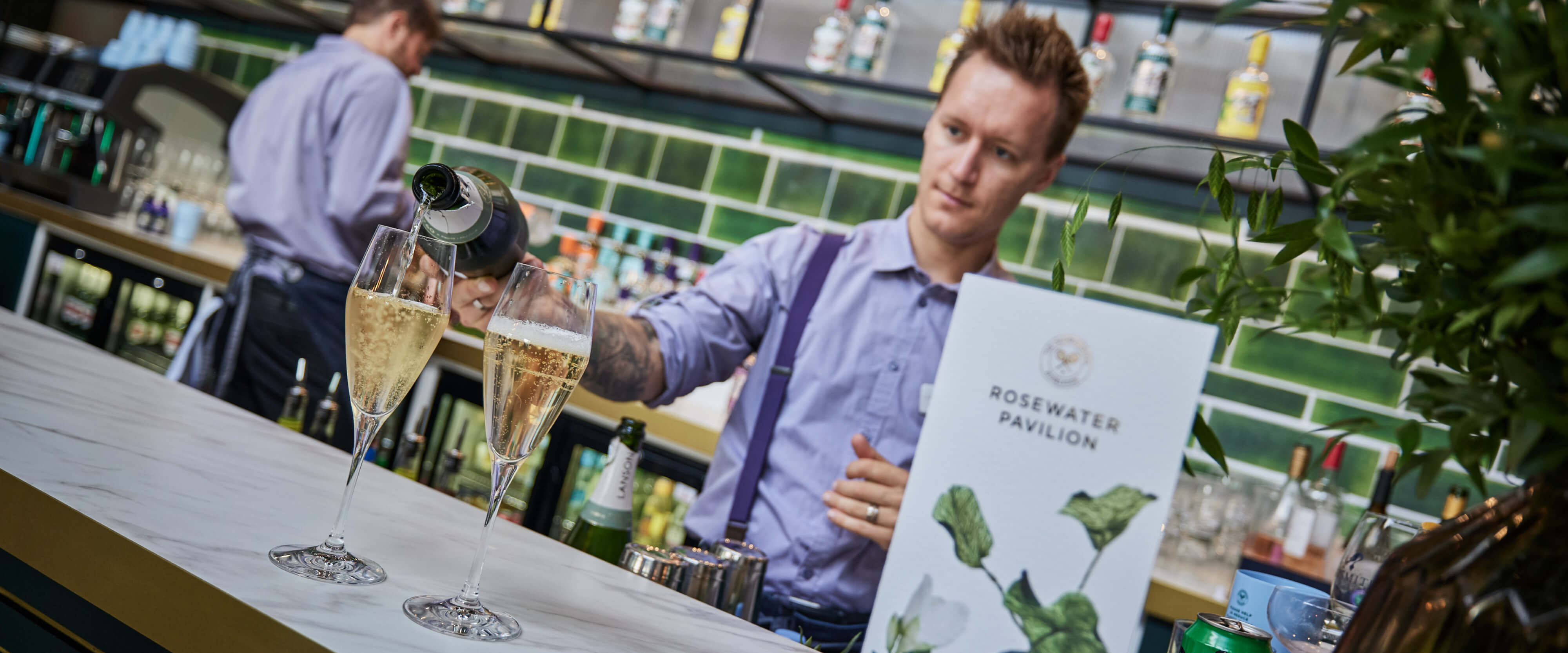 Rosewater Pavilion bar with champagne being poured by the barman 