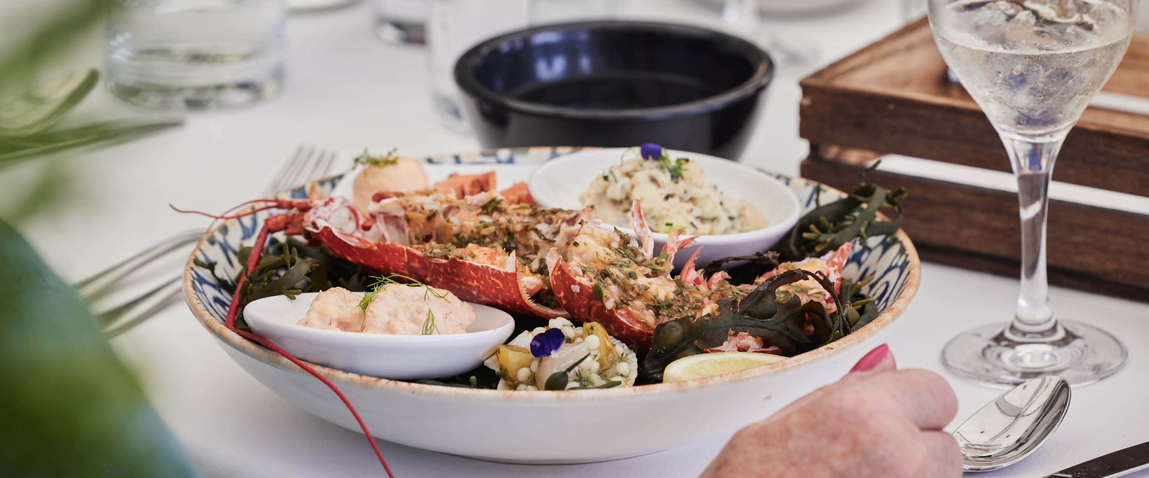 A seafood platter dish with lobster set at a table created by Michelin Star Chef Michel Roux Jr at The Championships Wimbledon